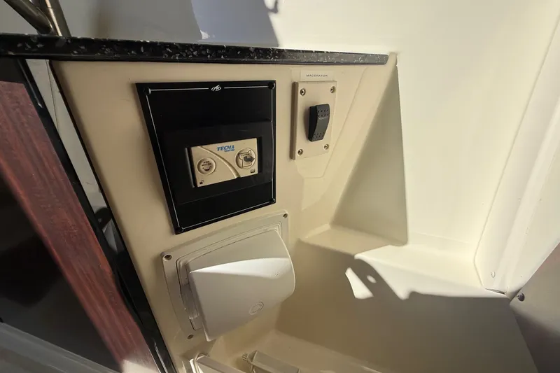 Slide: The Image of 2014 Monterey 328SS Super Sport boat control panel with Tecma system and macerator switch. - 53