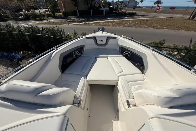 Slide: The Image of 2014 Monterey 328SS Super Sport boat interior with white seating and coastal view. - 57