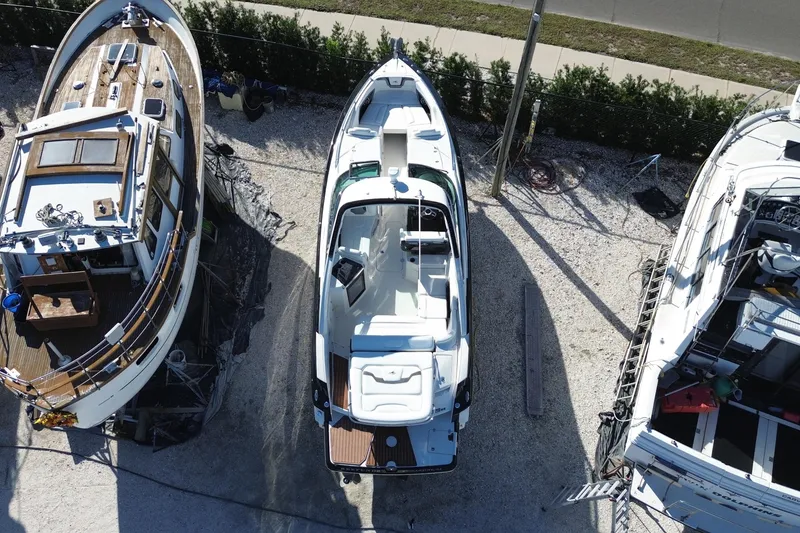 Slide: The Image of Aerial view of a 2014 Monterey 328SS Super Sport boat docked between two other boats. - 6
