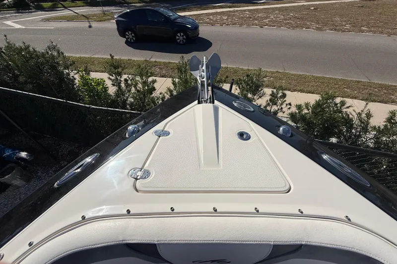 Slide: The Image of 2014 Monterey 328SS Super Sport boat bow with anchor, parked near road. - 61