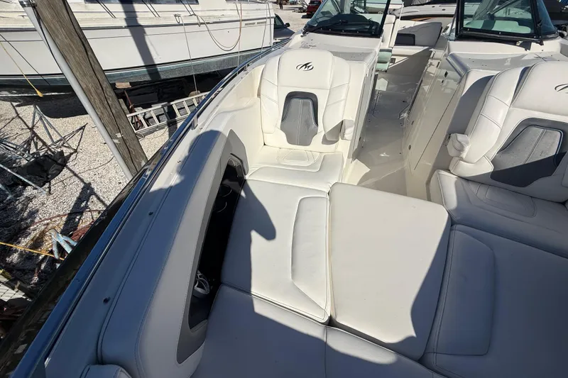 Slide: The Image of 2014 Monterey 328SS Super Sport boat interior with white seating and open deck layout. - 66