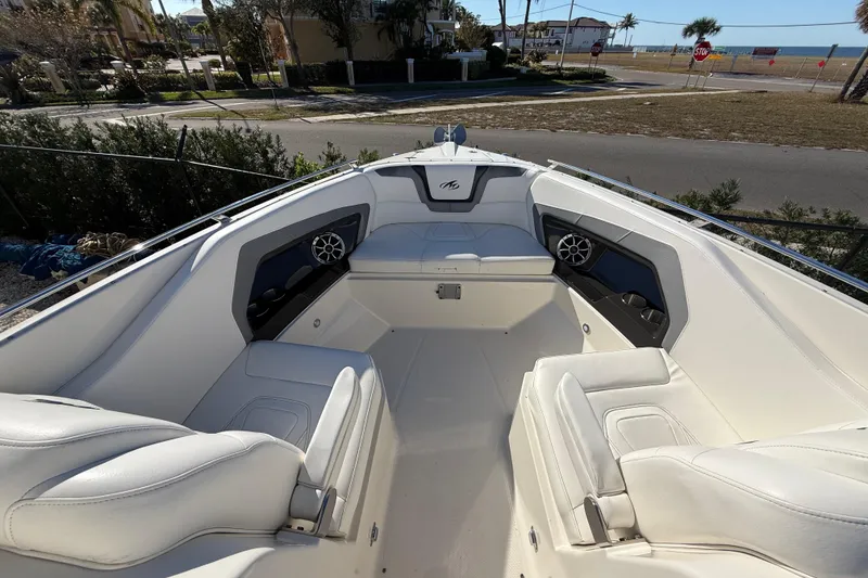 Slide: The Image of 2014 Monterey 328SS Super Sport boat interior with white seating and coastal view. - 68