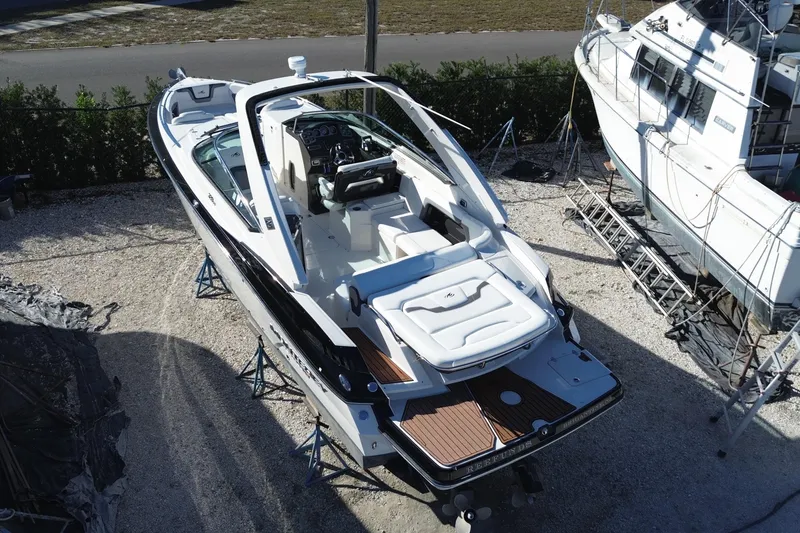 Slide: The Image of 2014 Monterey 328SS Super Sport boat on dry dock, showcasing sleek design and spacious interior. - 7