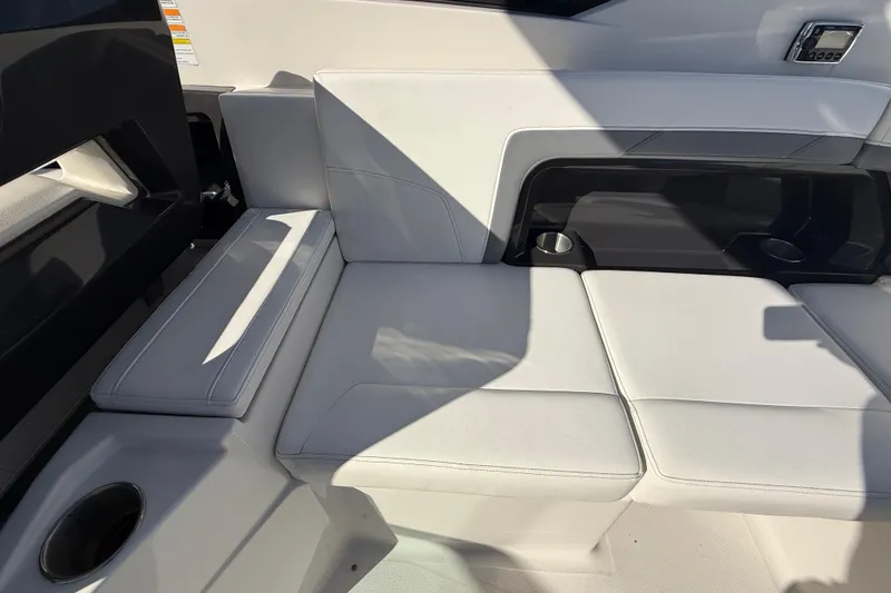 Slide: The Image of 2014 Monterey 328SS Super Sport boat interior with white seating and cup holders. - 82