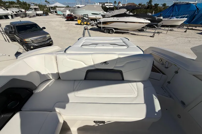 Slide: The Image of 2014 Monterey 328SS Super Sport boat interior with white seating, parked in a marina. - 84