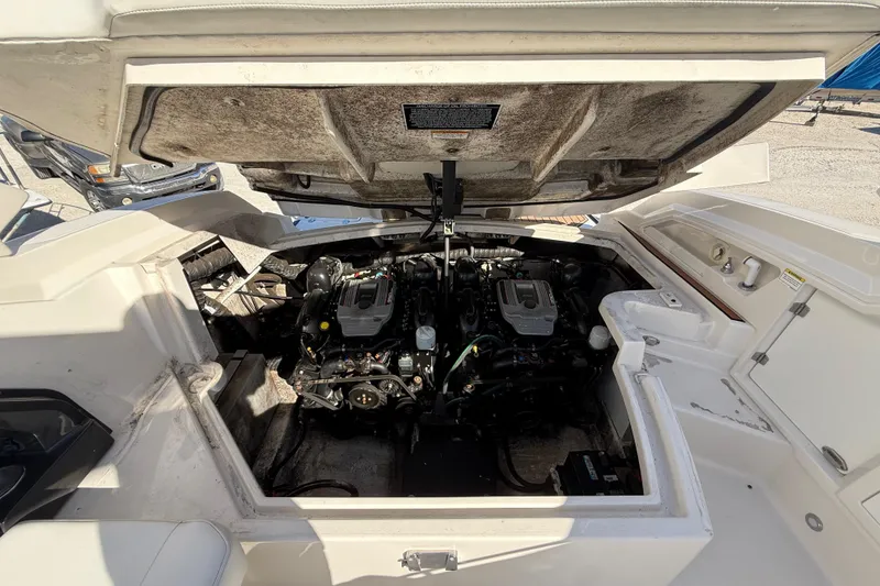 Slide: The Image of Open engine compartment of 2014 Monterey 328SS Super Sport boat, showcasing dual engines. - 87