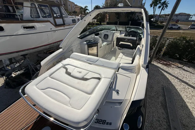 Slide: The Image of 2014 Monterey 328SS Super Sport boat with luxurious white interior and sleek design. - 9