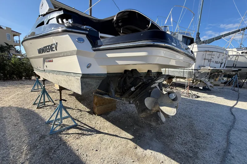 Slide: The Image of 2014 Monterey 328SS Super Sport boat on stands, showcasing propeller and hull. - 96