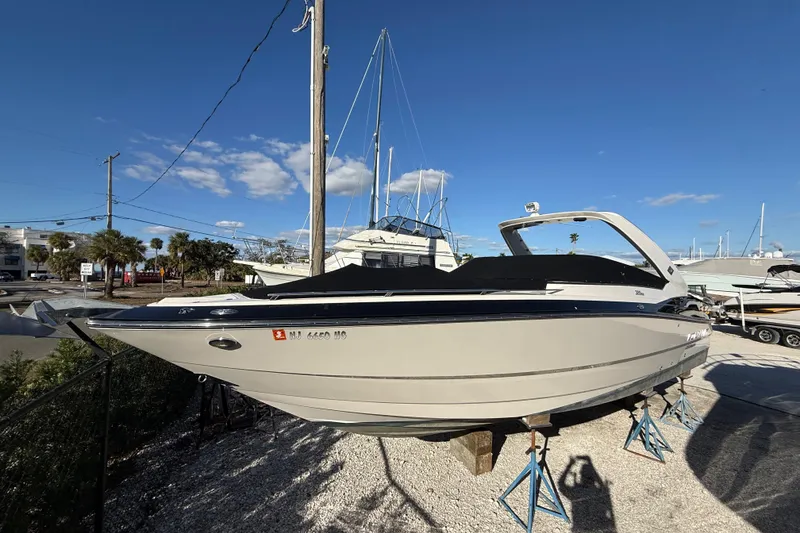 Slide: The Image of 2014 Monterey 328SS Super Sport boat on stands under clear blue sky. - 98