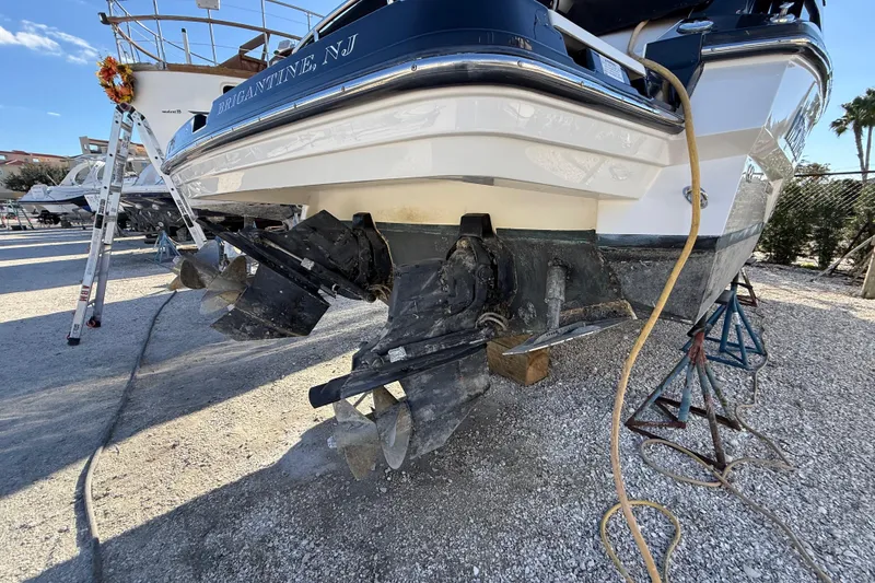 Slide: The Image of 2014 Monterey 328SS Super Sport boat on dry dock, showing dual propellers and hull. - 99
