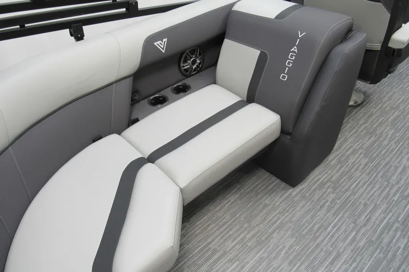 Slide: The Image of 2026 Viaggio Lago X22U boat interior with gray and white seating, cup holders, and speaker. - 11