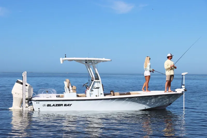 The Image of 2026 Blazer Bay 2440 boat with two people fishing on calm water. - 0
