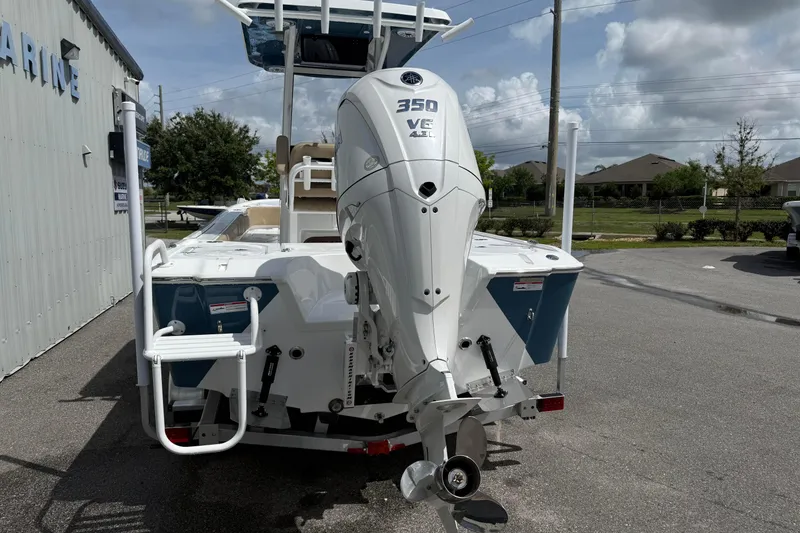 Slide: The Image of 2026 Blazer Bay 2440 boat with powerful 350 V6 engine, parked outdoors. - 10