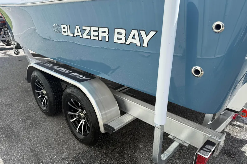 Slide: The Image of 2026 Blazer Bay 2440 boat on trailer, featuring sleek design and dual wheels. - 11