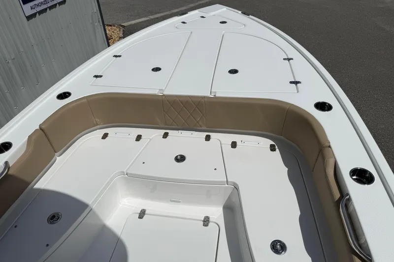 Slide: The Image of 2026 Blazer Bay 2440 boat deck with tan seating and storage compartments. - 14