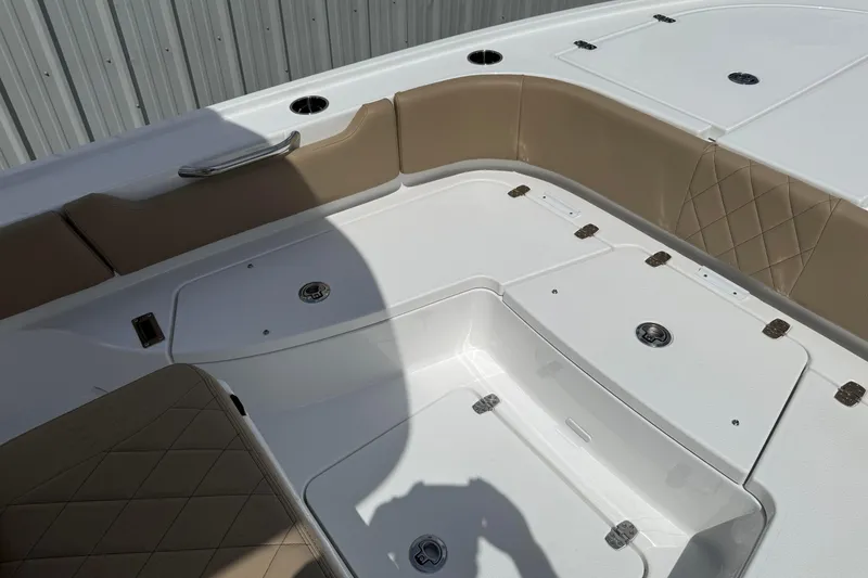 Slide: The Image of 2026 Blazer Bay 2440 boat interior with tan seating and storage compartments. - 15