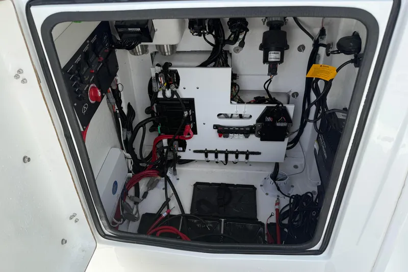 Slide: The Image of Electrical compartment of 2026 Blazer Bay 2440 boat, showcasing wiring and components. - 19