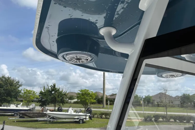 Slide: The Image of 2026 Blazer Bay 2440 boat with speaker system, parked outdoors under a cloudy sky. - 28