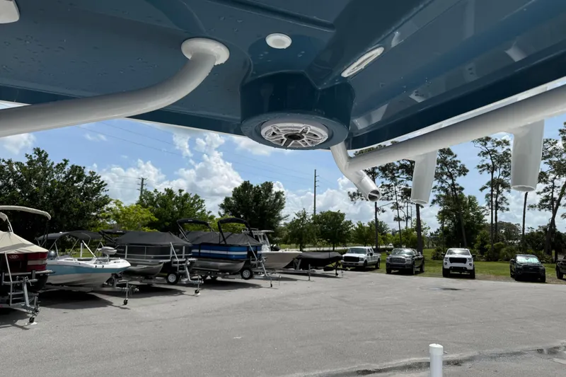 Slide: The Image of Outdoor view of Blazer Bay 2440 boat, 2026 model, with parked vehicles and boats. - 29