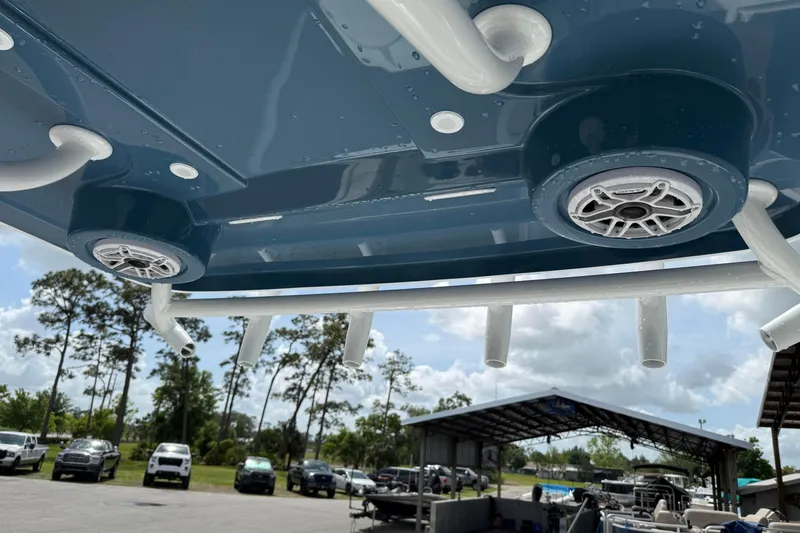 Slide: The Image of 2026 Blazer Bay 2440 boat speakers and rod holders under blue canopy. - 30