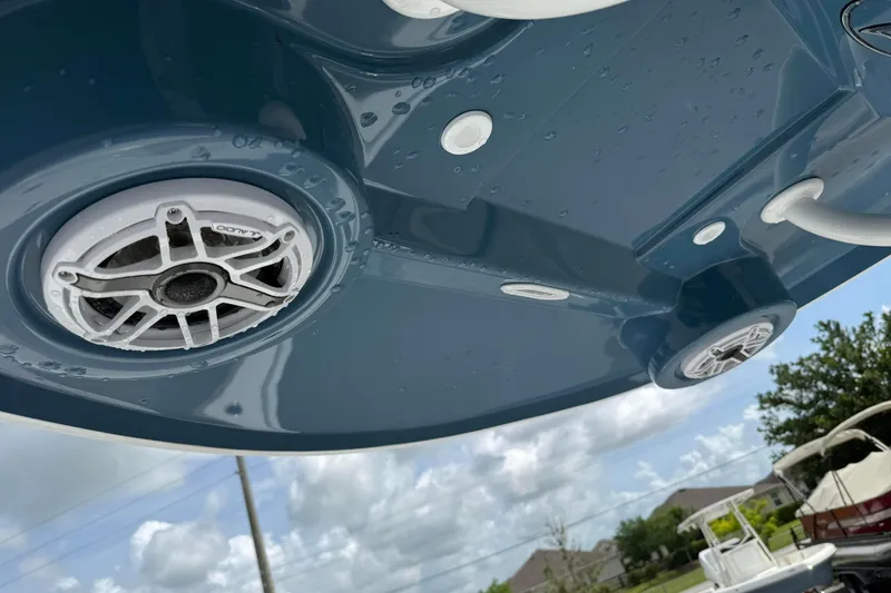 Slide: The Image of 2026 Blazer Bay 2440 boat speakers on a wet blue surface under cloudy sky. - 31