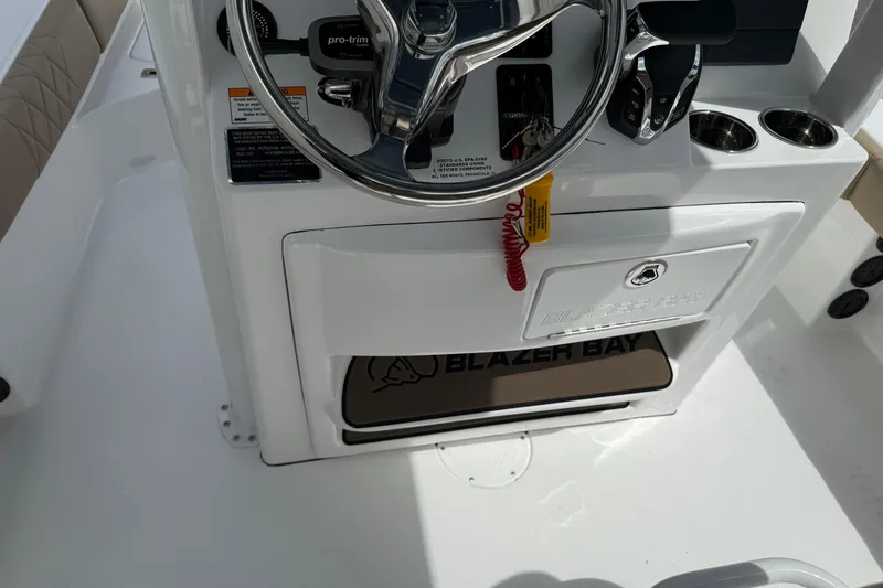 Slide: The Image of 2026 Blazer Bay 2440 boat console with steering wheel and controls. - 32