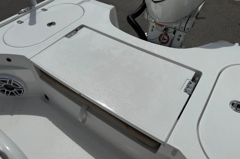 Slide: The Image of 2026 Blazer Bay 2440 boat deck with storage compartments and motor. - 33