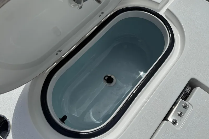Slide: The Image of Open storage compartment on 2026 Blazer Bay 2440 boat, featuring sleek design and secure latch. - 37