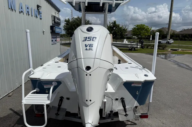 Slide: The Image of 2026 Blazer Bay 2440 boat with 350 V6 4.3L engine at a marine dealership. - 9