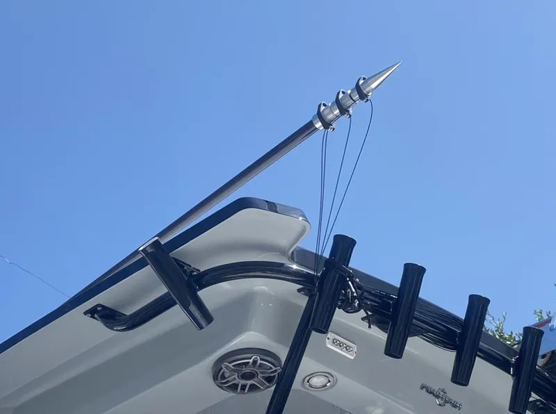Slide: The Image of Part of a boat with fishing rod holders and an antenna against a blue sky. - 9