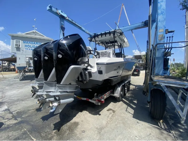 Slide: The Image of A 2021 Fountain 38 Tournament Edition boat with three outboard engines on a trailer at the harbor. - 3