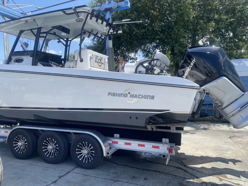 Slide: The Image of A 2021 Fountain 38 Tournament Edition boat on a trailer, featuring a powerful outboard motor. - 2