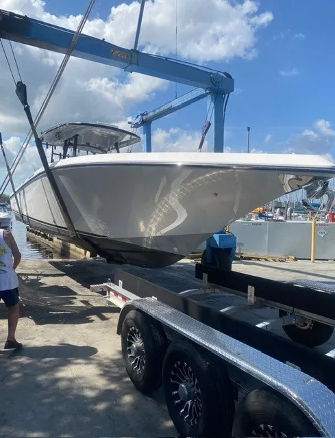 Slide: The Image of A Fountain 38 Tournament Edition boat being lifted onto a trailer by a crane. - 10