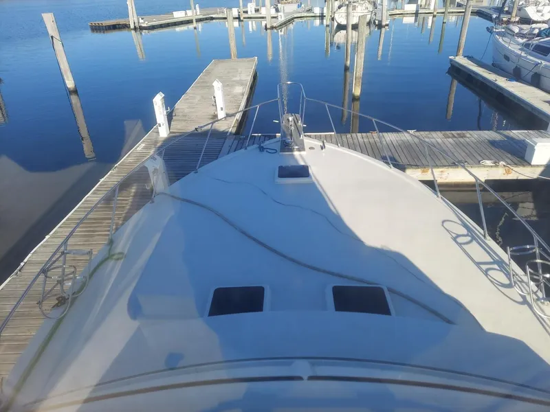 Slide: The Image of 1985 Post 43 Convertible yacht docked at marina, calm water reflections. - 11