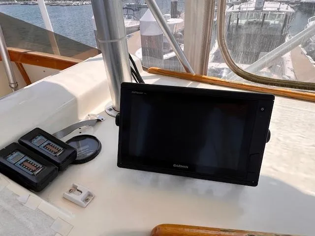 Slide: The Image of 1985 Post 43 Convertible boat dashboard with Garmin GPS and control panels. - 12