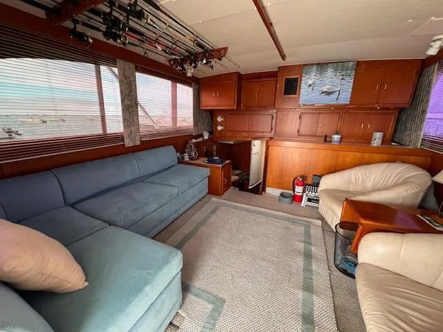 Slide: The Image of Interior of 1985 Post 43 Convertible yacht with cozy seating and fishing rods. - 16