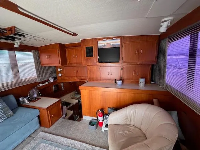 Slide: The Image of Interior of 1985 Post 43 Convertible yacht with wood cabinetry and cozy seating. - 17