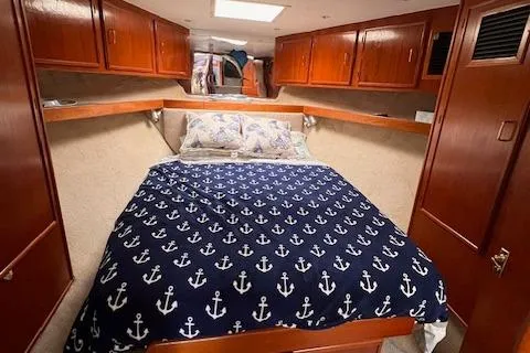 Slide: The Image of Cozy cabin interior of 1985 Post 43 Convertible with anchor-themed bedding. - 20