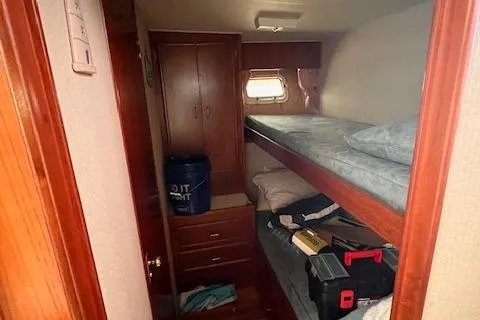 Slide: The Image of 1985 Post 43 Convertible cabin with bunk beds and wooden storage. - 23