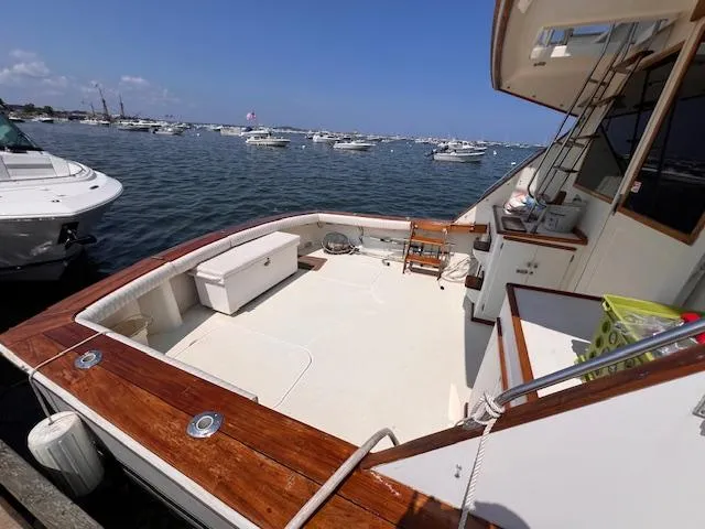 Slide: The Image of 1985 Post 43 Convertible yacht with spacious deck, docked in a busy marina. - 6