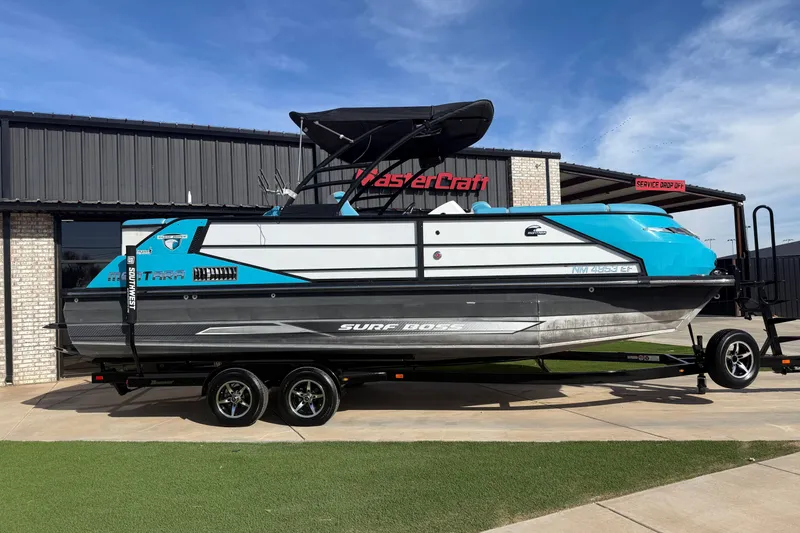 Slide: The Image of 2020 Montara Surf Boss boat on trailer outside MasterCraft building. - 1