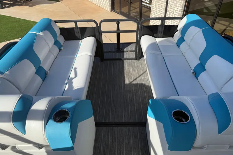 Slide: The Image of 2020 Montara Surf Boss boat interior with blue and white seating, cup holders, and carpeted floor. - 12