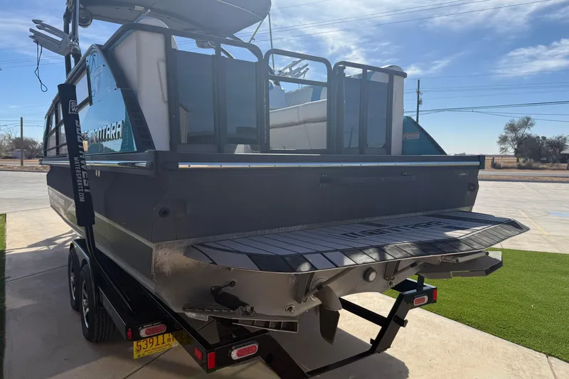 Slide: The Image of 2020 Montara Surf Boss boat on trailer, rear view in sunny outdoor setting. - 15