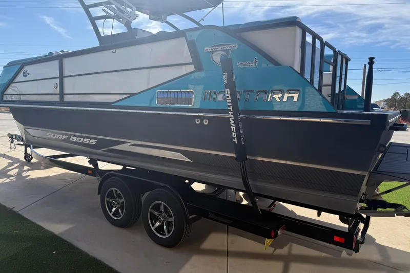 Slide: The Image of 2020 Montara Surf Boss boat on trailer, side view, blue and gray design. - 16