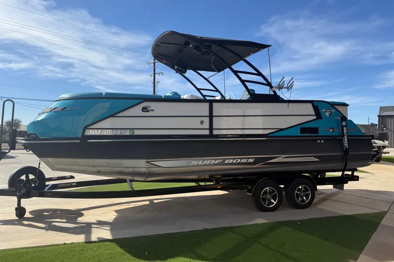 Slide: The Image of 2020 Montara Surf Boss boat on trailer, parked outdoors under clear blue sky. - 2