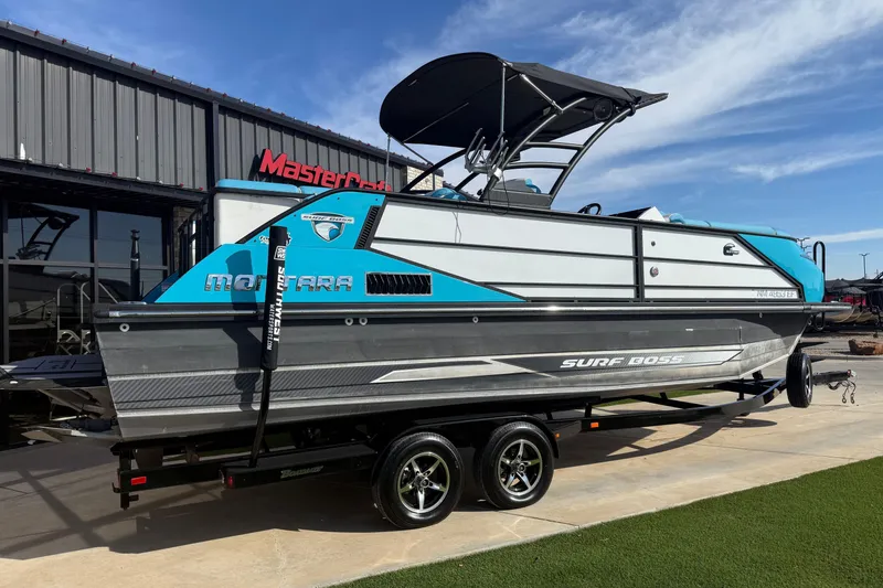 Slide: The Image of 2020 Montara Surf Boss boat on trailer, displayed outside MasterCraft building. - 3