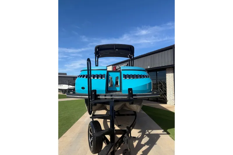 Slide: The Image of 2020 Montara Surf Boss boat on trailer, vibrant blue, parked outdoors. - 5