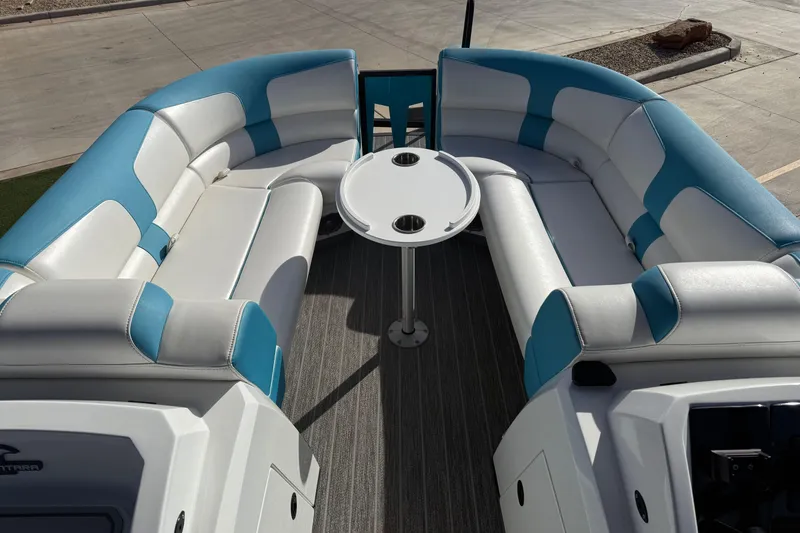 Slide: The Image of 2020 Montara Surf Boss boat interior with blue and white seating and a central table. - 7