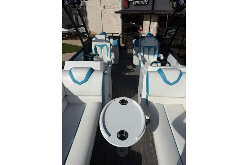 Slide: The Image of 2020 Montara Surf Boss boat interior with white and blue seating and round table. - 8