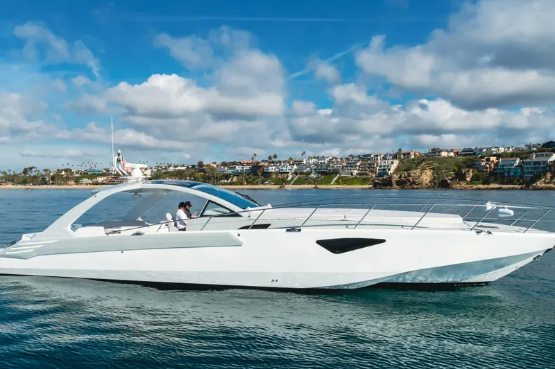 Slide: The Image of Luxurious 2017 Custom 60 yacht cruising near scenic coastal homes under blue skies. - 0
